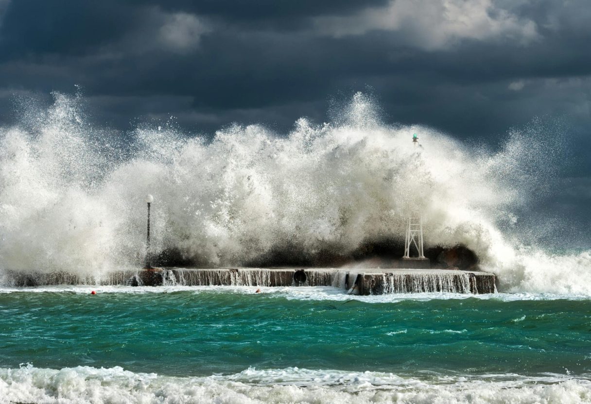 pexels-photo-826388-826388 Dramatic ocean waves crashing against a concrete structure in Pantanassa, capturing nature's raw power.