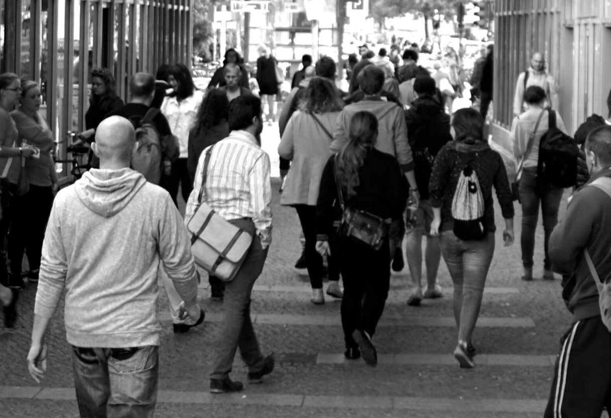 pexels-photo-9816-9816 A bustling street scene capturing diverse pedestrians walking outdoors in an urban setting.